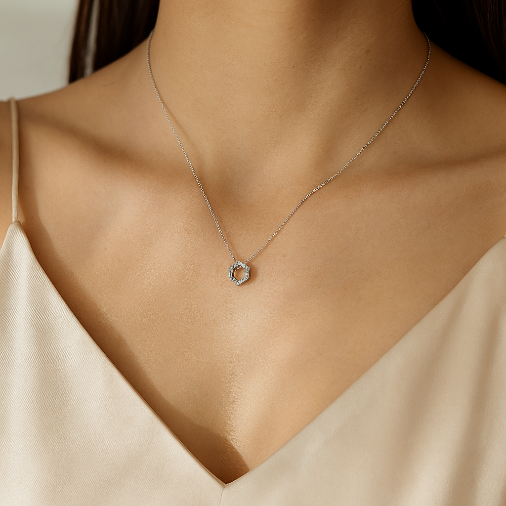 Hexagon-shaped pendant inspired by a honeycomb, adorned with clear cubic zirconia stones.
