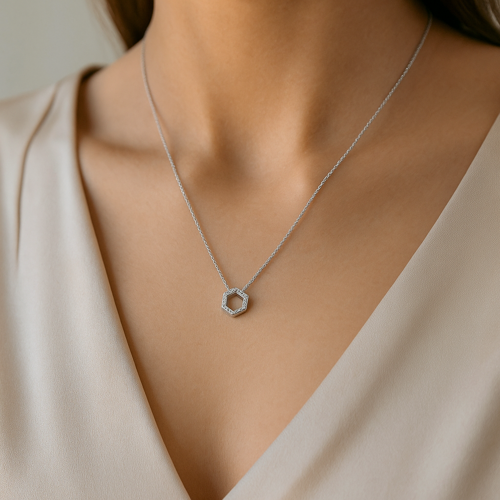 Hexagon-shaped pendant inspired by a honeycomb, adorned with clear cubic zirconia stones.