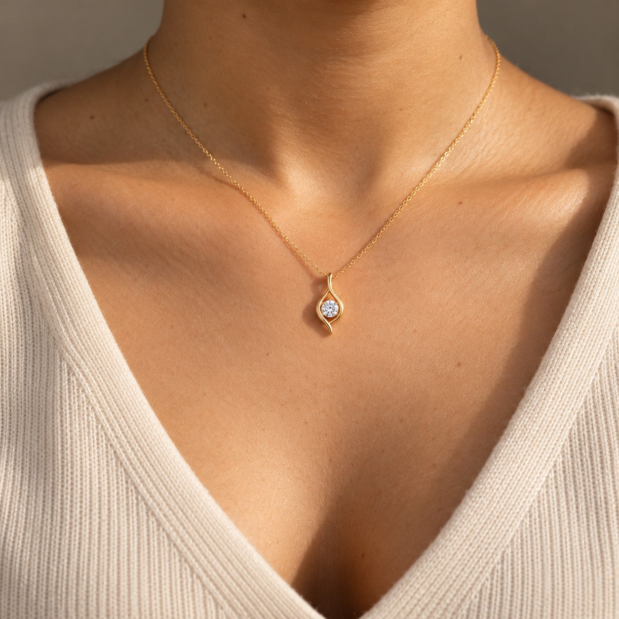 Eterna Flame gold flame teardrop pendant worn on the neck, Silvk 925 silver jewellery