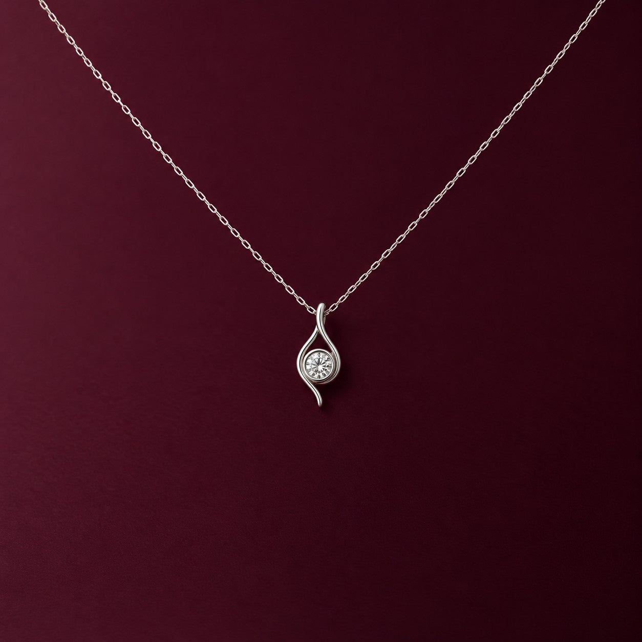Eterna Flame silver pendant on a deep burgundy background, Silvk 925 silver jewellery
