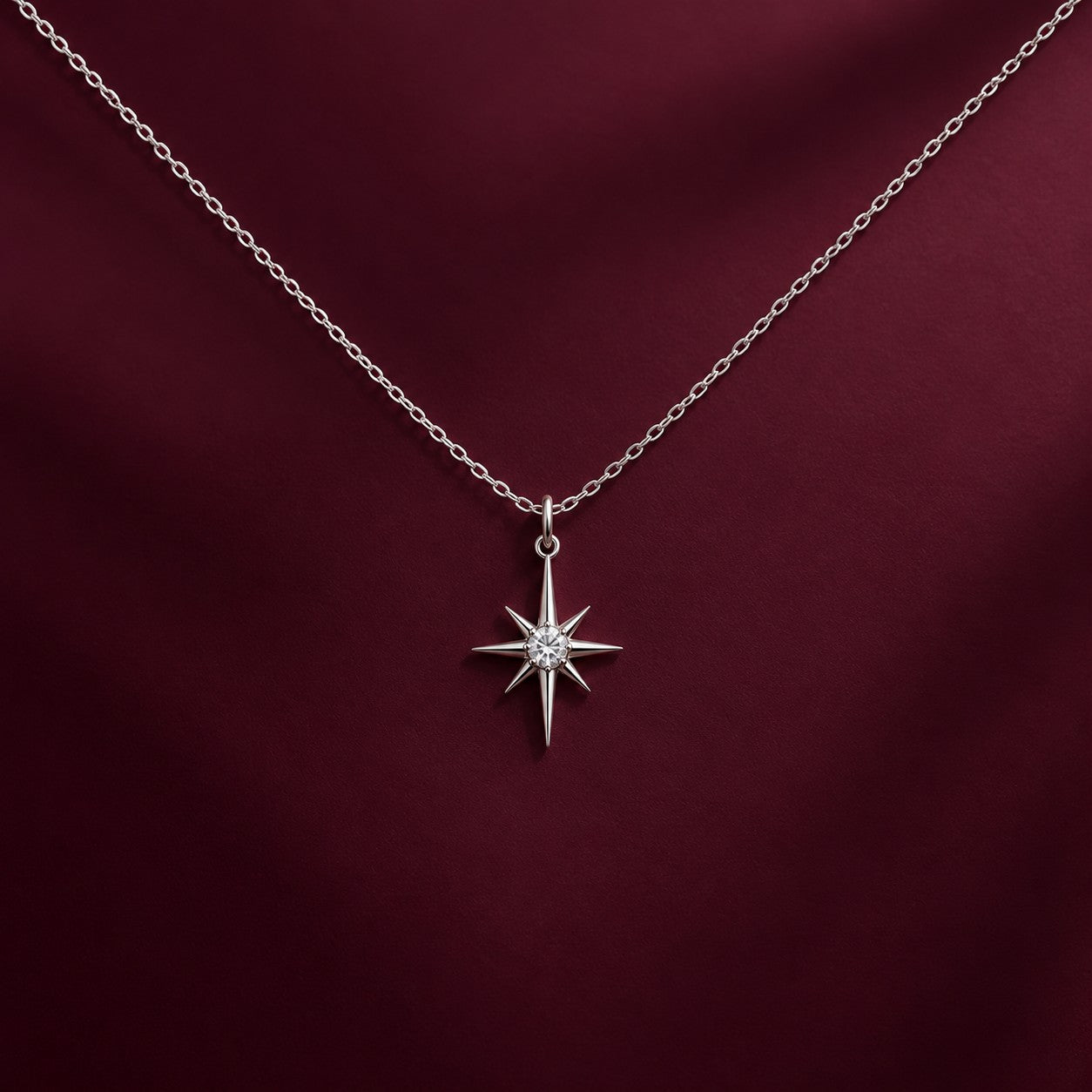 Eternal Star silver star pendant on a deep burgundy background, Silvk 925 silver jewellery