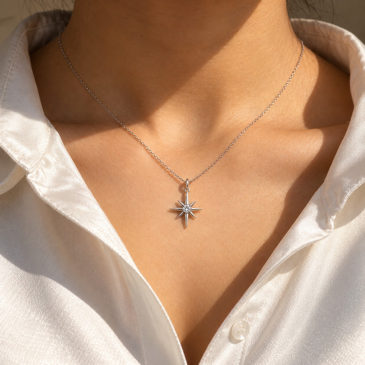 Eternal Star silver star pendant worn on the neck with a white shirt, Silvk 925 silver jewellery