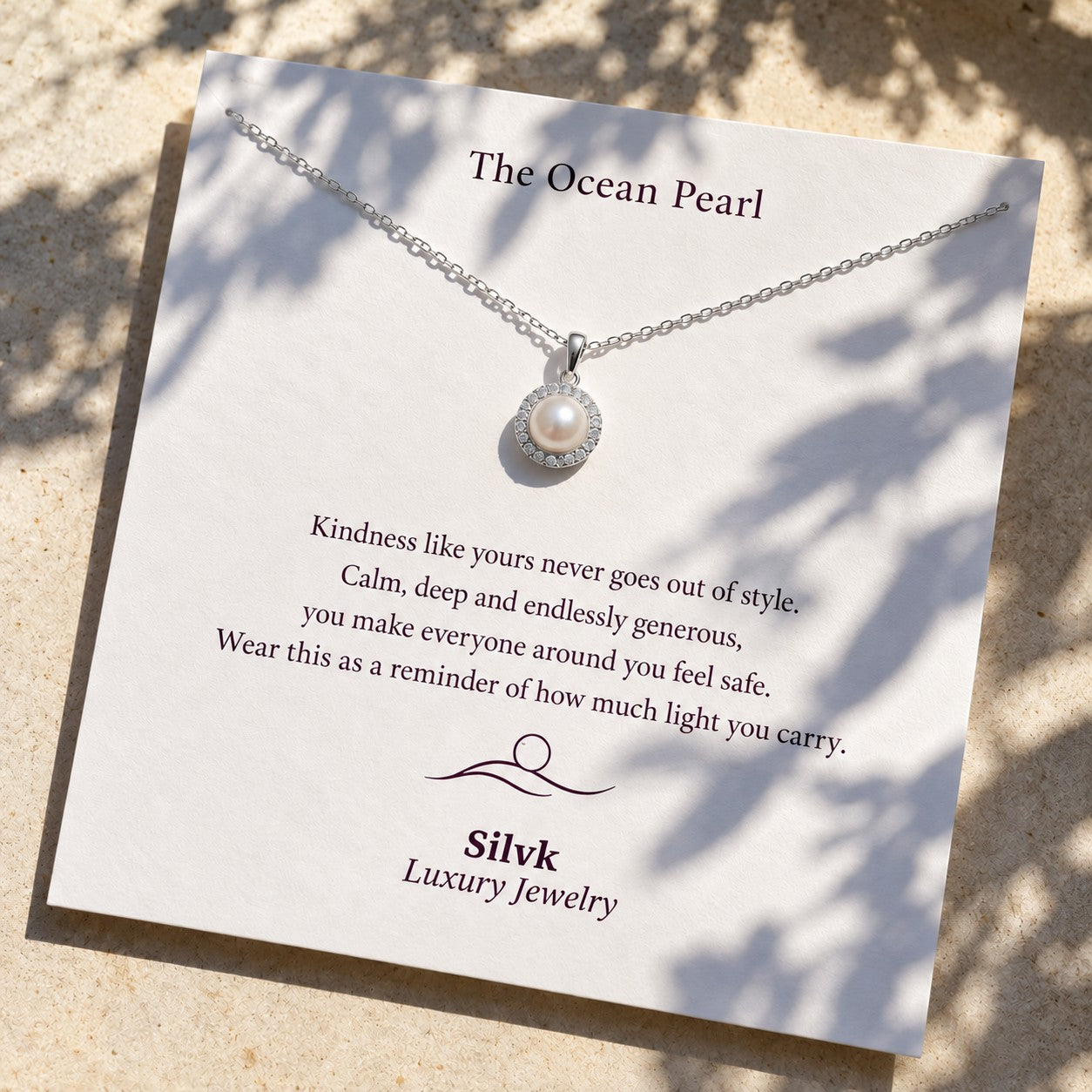The Ocean Pearl pendant on its message card in sunlight, Silvk 925 silver jewellery